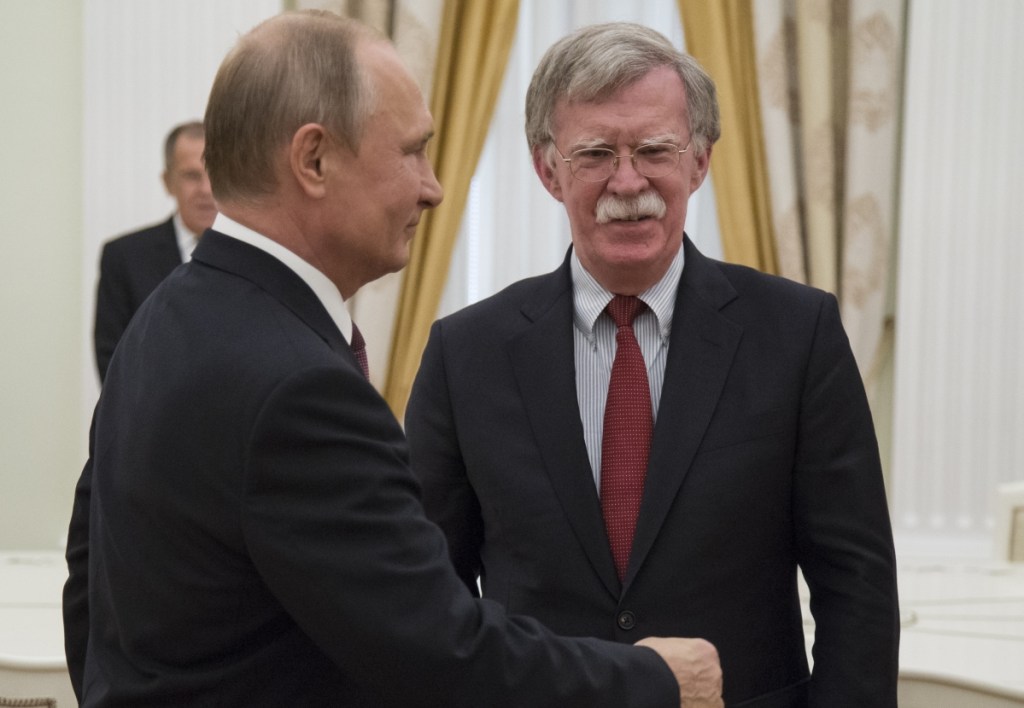 Russian President Vladimir Putin, left, meets with John Bolton, U.S. national security adviser, in the Kremlin Wednesday to finalize plans for a Putin-Trump summit.