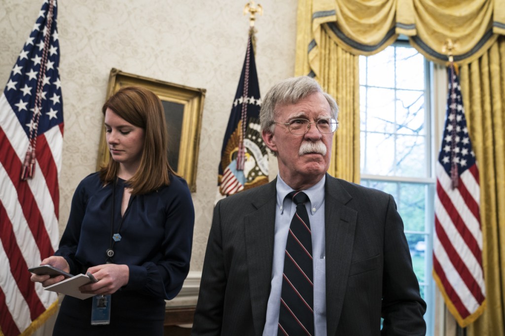 Cari Lutkins (left) and national security advisor John Bolton listen as President Donald Trump speaks during a meeting with Chancellor Merkel of Germany in the Oval Office at the White House on April 27, 2018. MUST CREDIT: Washington Post photo by Jabin Botsford.