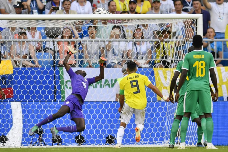 A shot by Colombia's Yerry Mina eludes Senegal goalkeeper Khadim Ndiaye for the only goal Thursday in Colombia's 1-0 victory that eliminated Senegal from the World Cup.