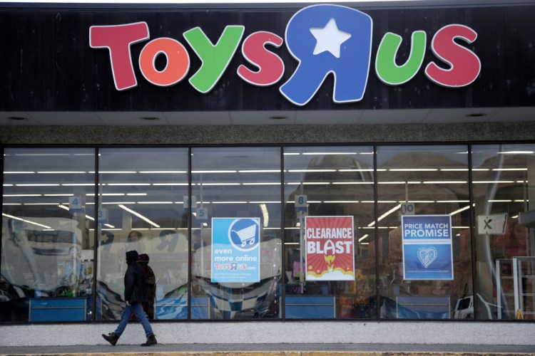 A person walks near the entrance to a Toys R Us store in Wayne, N.J., in January. Toys R Us is closing its last U.S. stores by Friday, after poor sales during the holiday season.