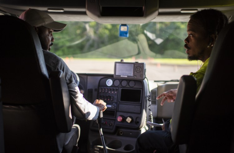 TDDS Technical Institute in central Ohio is training new truck drivers for an industry desperate for recruits. Dione Valentine, left, and Amos Moore get a hands-on lesson at TDDS as they work for their commercial driver's licenses.