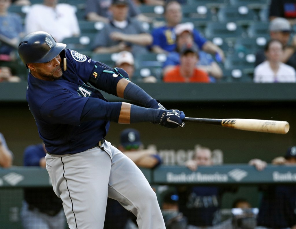 The Mariners' Nelson Cruz singles in the 10th inning Thursday at Baltimore. Seattle took advantage of two errors in the inning to come away with a 4-2 victory over the Orioles.