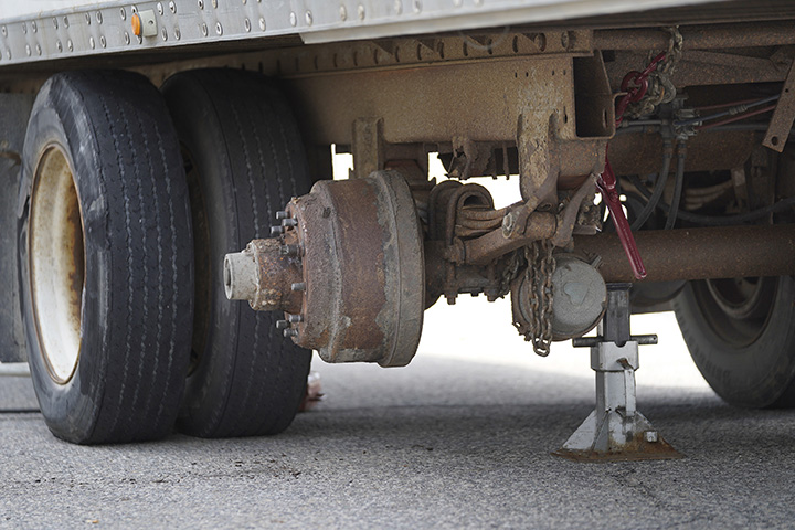 One of the rear axles of this trailer was damaged when the truck struck the toll booth.