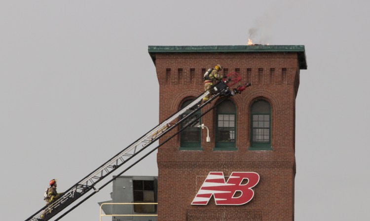 Firefighters battle a fire at the New Balance factory in Skowhegan on Friday.