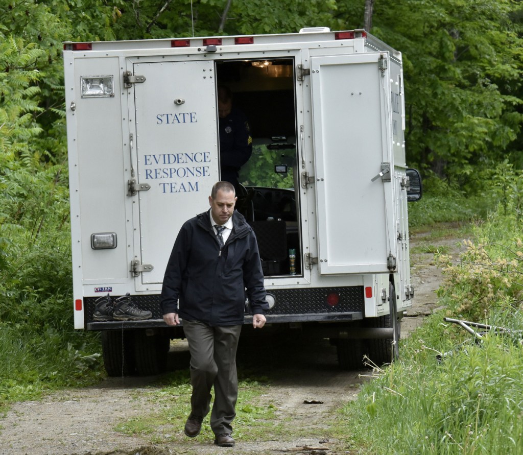 Maine State Police detective Jason Richards exits the Major Crimes Unit vehicle near an abandoned building off Route 150 in Skowhegan as police continue their investigation into the disappearance of Tina Stadig, who has been missing for more than a year.