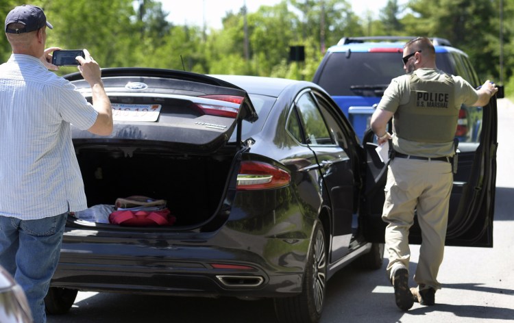 Federal and state investigators process a vehicle on May 30 after agents stopped it and arrested the female operator, Yashonia Michele Davis, who was allegedly involved with a homicide in New York.