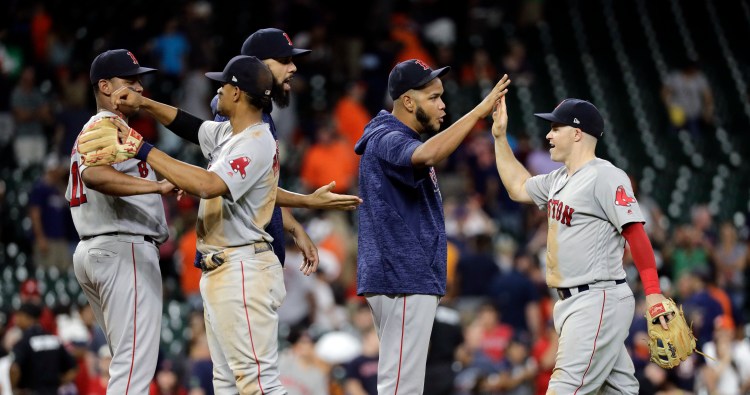 The Boston Red Sox celebrate after their 9-3 win over the Houston Astros on Sunday in Houston. Boston won the final two games of a four-game series with the Astros. 