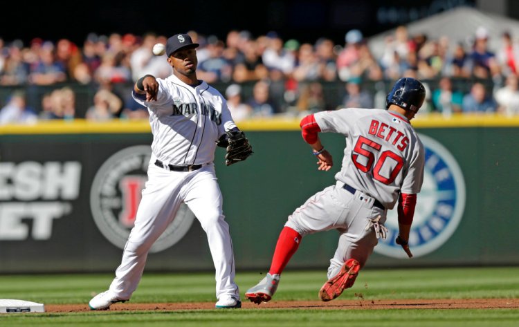 Mookie Betts is forced out at second base as Mariners shortstop Jean Segura throws to first to complete a double play on Andrew Benintendi during the first inning of Saturday night's game.