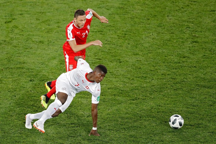Serbia's Nemanja Matic, top, vies for the ball with Switzerland's Breel Embolo during the group E match between Switzerland and Serbia at the 2018 soccer World Cup in the Kaliningrad Stadium in Kaliningrad, Russia.