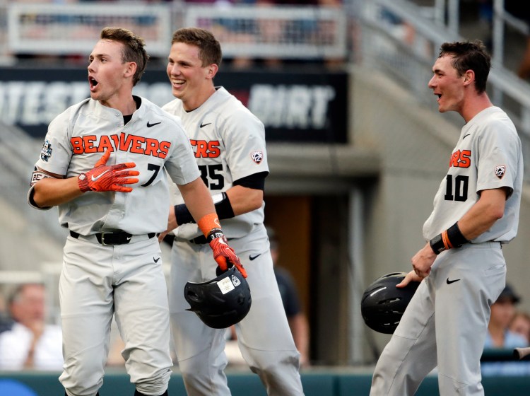 Oregon State's Tyler Malone, 7, celebrates his three-run home run against Mississippi State in the third inning with Adley Rutschman, 35, and Michael Gretler in a College World Series elimination game Sunday in Omaha, Neb. Oregon State has won 109 of 127 games in the last two seasons, but feels it needs a victory in the CWS to validate its success.