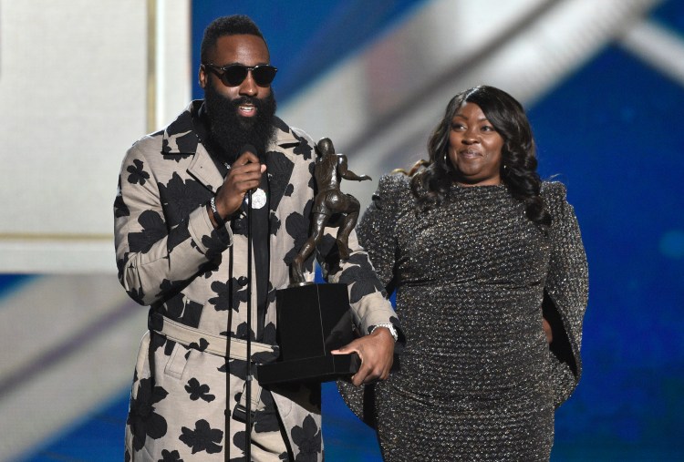 NBA player James Hardin, of the Houston Rockets, left, accepts the most valuable player award as his mother Monja Willis looks on at the NBA Awards on Monday, June 25, 2018, at the Barker Hangar in Santa Monica, Calif. 