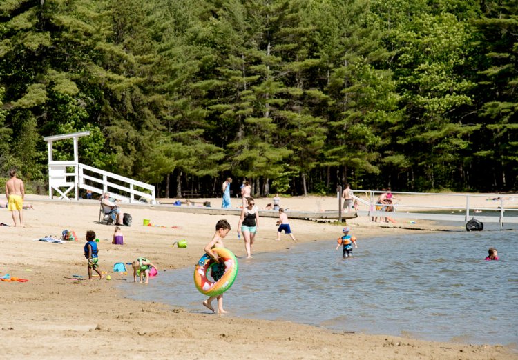 Children play on the beach at Range Pond State Park in Poland on Tuesday afternoon. A 13-year-old Lewiston student on a school field trip drowned there in the morning.