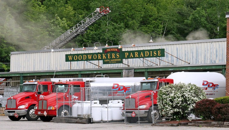 Smoke and steam rise Saturday morning from the Woodworkers Paradise building on Route 2, where Rumford Fire Chief Chris Reed said flames erupted in a rented marijuana grow room. 
