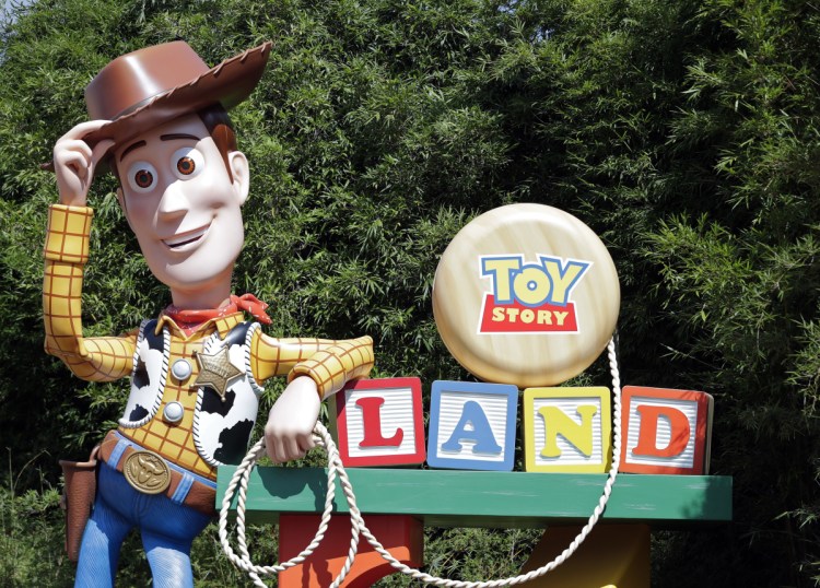 A statue of the character Sheriff Woody greets visitors at the entrance to Toy Story Land in Disney's Hollywood Studios at Walt Disney World in Lake Buena Vista, Fla.