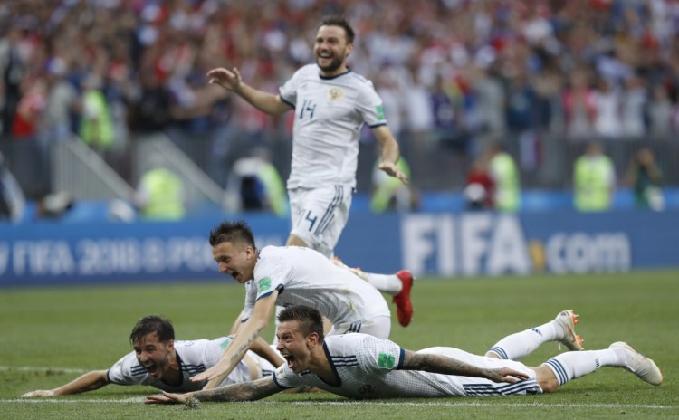 Russia's Fyodor Smolov, right, celebrates with teammates after Russia defeated Spain in a penalty shoot out during their elimination match at the 2018 World Cup in Moscow, Russia on Sunday.