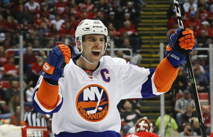 Center John Tavares has plenty to celebrate. He's headed to the Toronto Maple Leafs, the team he grew up rooting for, on a seven-year, $77 million contract after starting his career with the Islanders.