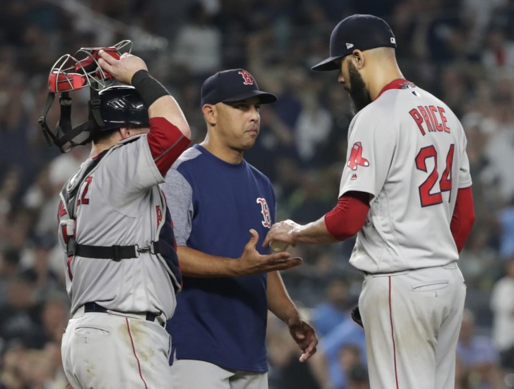 David Price of the Red Sox hands the ball to Manager Alex Cora while leaving in the fourth inning Sunday night. Price gave up five home runs in 3  innings.