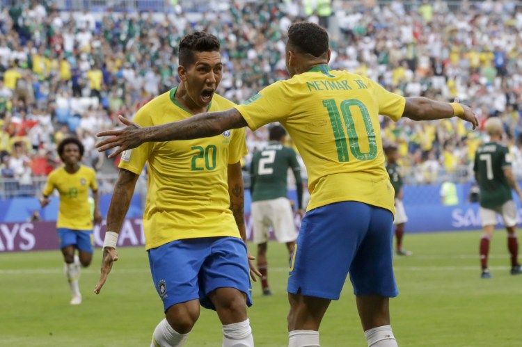 Brazil's Roberto Firmino, left, celebrates with Brazil's Neymar, right, after scoring his side's second goal against Mexico at the 2018 World Cup on Monday.