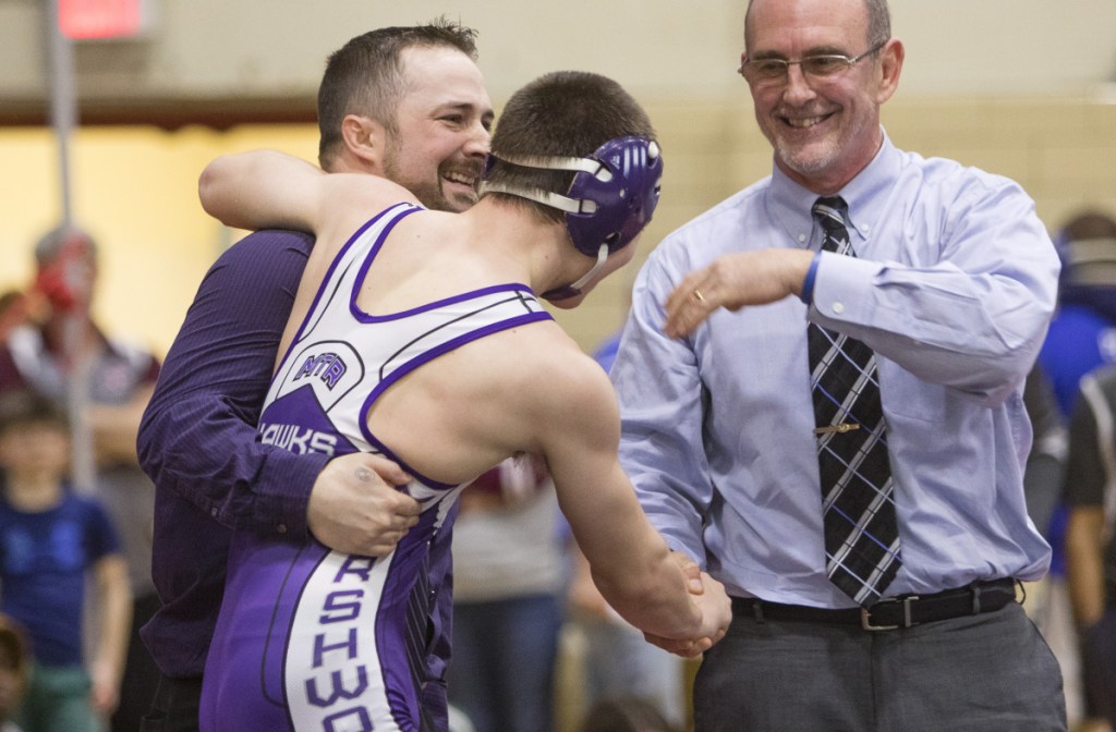 SANFORD, ME - FEBRUARY 17: Marshwood 126 lb wrestler Liam Coomey celebrates a victory over Noble's Sam Martel with coaches Pat Howard and Matt Nix during the Class A state wrestling championship in Sanford, on Saturday, February 17, 2018. (Photo by Carl D. Walsh/Staff Photographer)