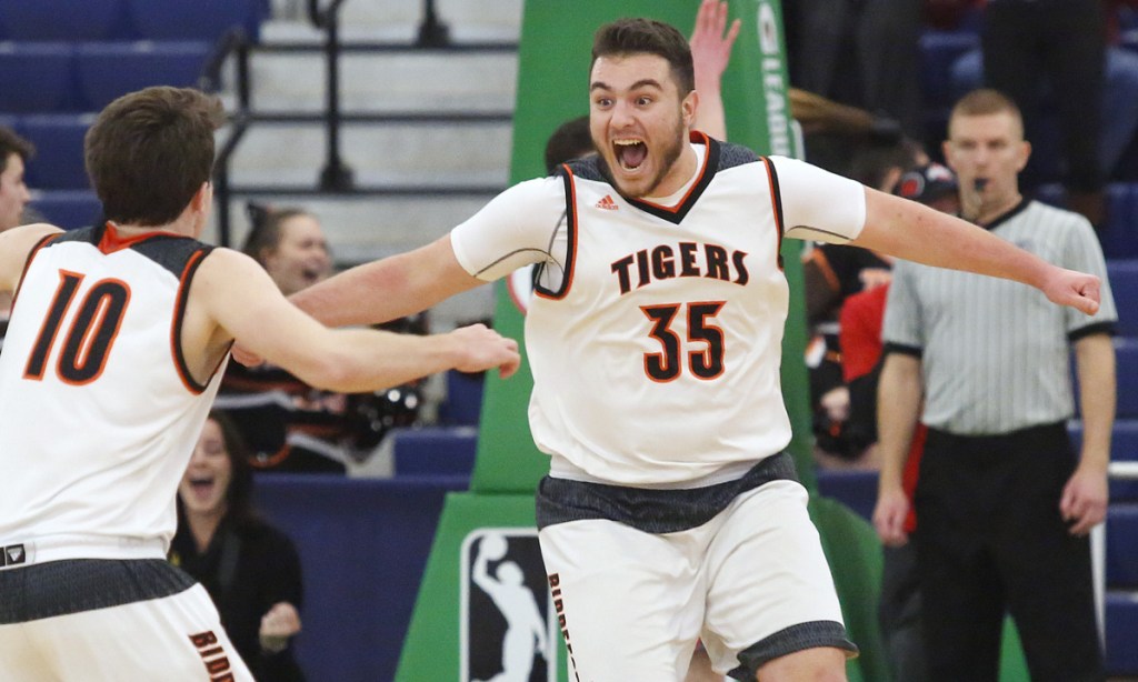 Zach Reali, right, celebrates with teammate Carter Edgerton after his buzzer-beating putback – his only basket of the game – gave Biddeford a 50-48 win over Brunswick in a Class A South quarterfinal in February.
