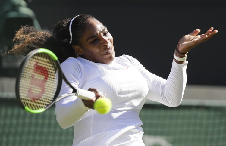 Serena Williams hits a return to Arantxa Rus during their first-round match Monday at Wimbledon. Williams won 7-5, 6-3.