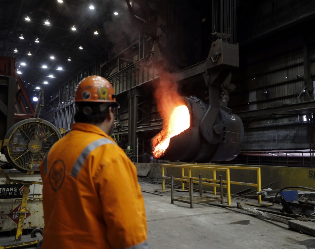 FILE- In this Thursday, June 28, 2018, file photo senior melt operator Randy Feltmeyer watches a giant ladle as it backs away after pouring its contents of red-hot iron into a vessel in the basic oxygen furnace as part of the process of producing steel at the U.S. Steel Granite City Works facility in Granite City, Ill. On Monday, July 2, the Institute for Supply Management, a trade group of purchasing managers, issues its index of manufacturing activity for June.