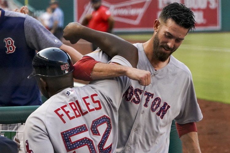 Red Sox starting pitcher Rick Porcello, right, celebrates with third base coach Carlos Febles after Porcello hit a three-run double during the second inning of the Red Sox' 4-3 win over the Nationals on Monday in Washington.