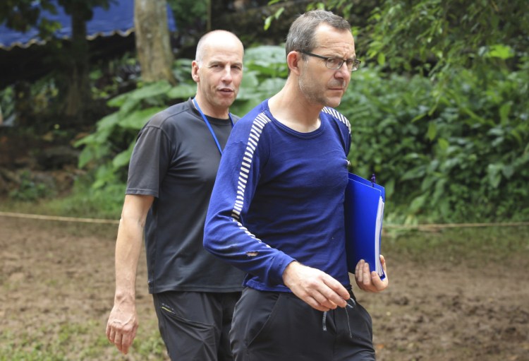 Richard Stanton, left, and John Volanthen arrive in Mae Sai, Chiang Rai province, in northern Thailand, on Tuesday. They found the 12 boys and soccer coach in a partially flooded cave in northern Thailand, where they had been lost for 10 days.