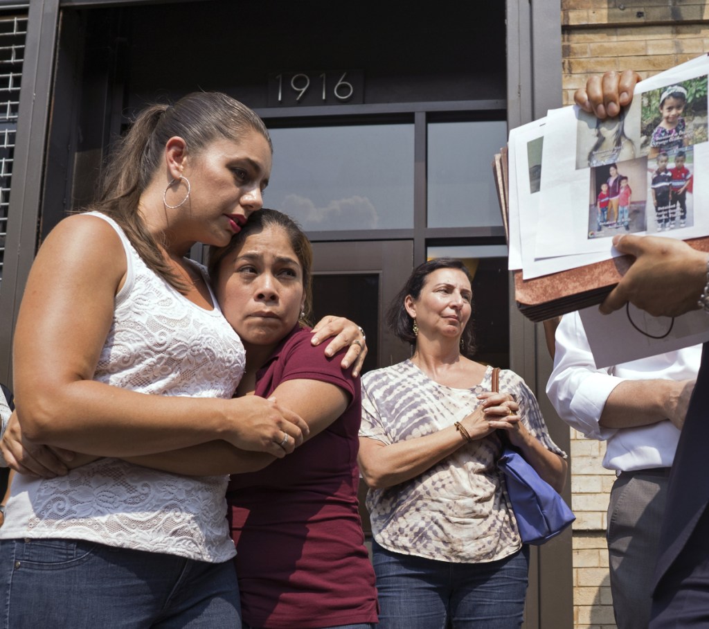 Yeni Gonzalez, a Guatemalan mother who was separated from her three children at the U.S.-Mexico border, center, is embraced by volunteer Janey Pearl, center left, during a news conference Tuesday in New York. Gonzalez saw her kids for the first time since mid-May.