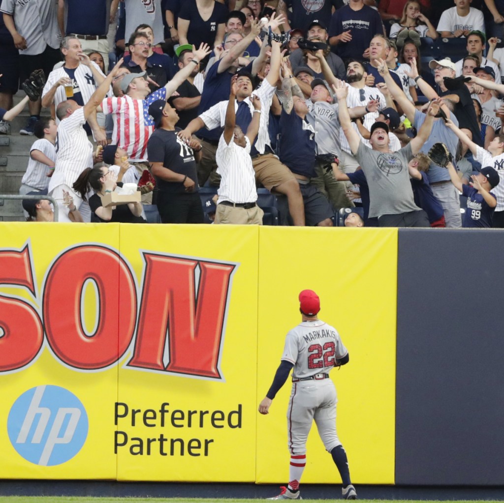 Braves right fielder Nick Markakis watches a two-run home run by New York's Aaron Hicks in the first inning Tuesday night in New York. The Yankees held on for an 8-5 win.