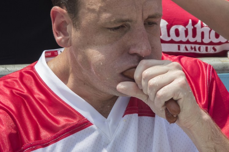 Reigning champion Joey Chestnut eats two hot dogs at a time during the men's competition of the Nathan's Famous Fourth of July hot dog eating contest.