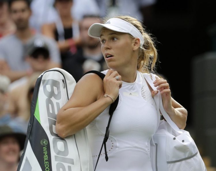 Caroline Wozniacki of Denmark leaves the court after being defeated by Ekaterina Makarova of Russia in their women's singles match in London on Wednesday.