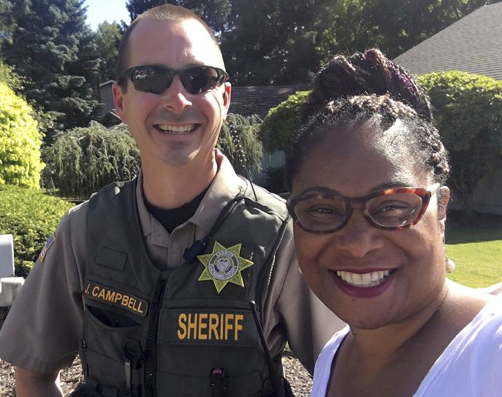 Oregon state Rep. Janelle Bynum poses with a Clackamas County sheriff's officer after he stopped her in Clackamas, Ore.