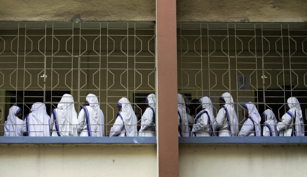 Nuns of Missionaries of Charity, the order founded by Mother Teresa, stand in a queue to cast their vote during an election in Kolkata, India. Police say they have arrested a nun and another worker at a shelter run by Mother Teresa's charity for allegedly selling a baby.
