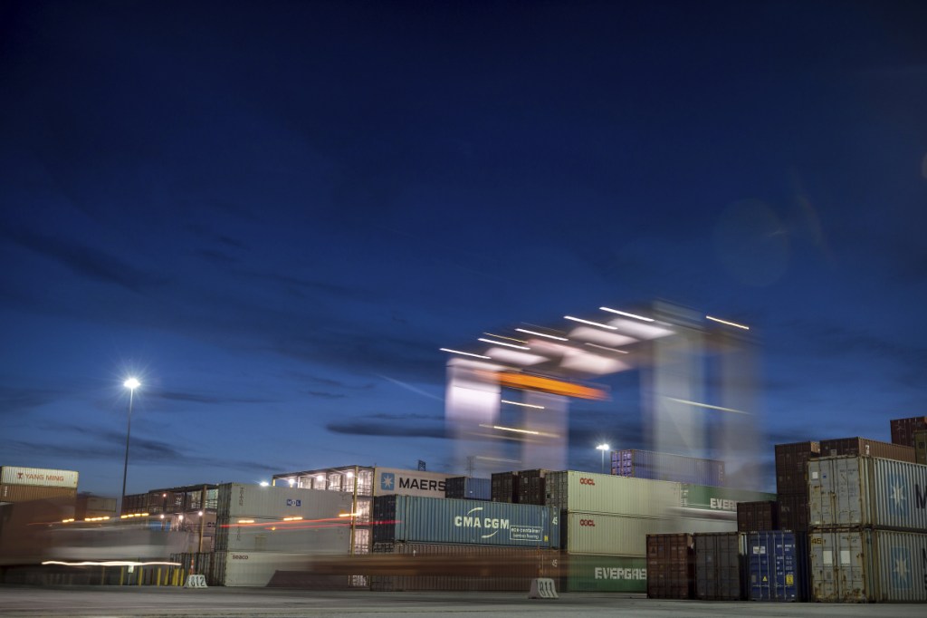 A rubber tire gantry moves to the next stack of shipping containers at the Port of Savannah in Savannah, Ga., on Thursday. The United States and China launched what Beijing called the "biggest trade war in economic history" Friday, imposing tariffs on billions of dollars of each other's goods amid a spiraling dispute over technology and trade.