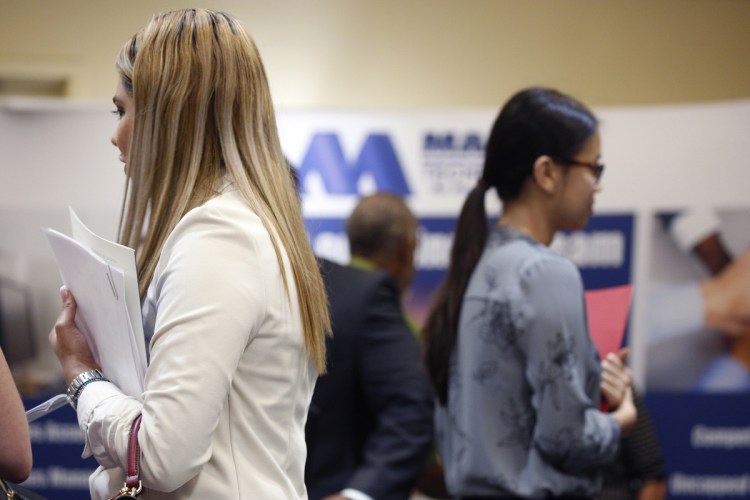 Job seekers hold resumes while waiting to speak with representatives during a National Career Fairs event in Tampa, Florida, on May 23, 2018. MUST CREDIT: Bloomberg/Luke Sharrett.