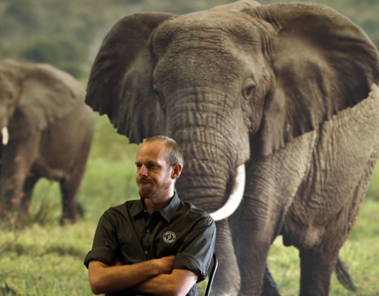 Erik Mararv, manager of the Garamba National Park in Congo, is shown against a poster of elephants during a 2016 interview. 
