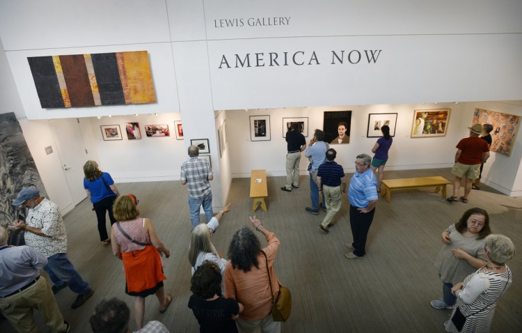 The crowd looks over the work at the America Now Exhibit at the Portland Public Library on Friday.