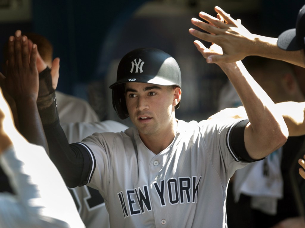 Tyler Wade celebrates Sunday after scoring the 10th-inning run on Brett Gardner's single that lifted the New York Yankees over the Toronto Blue Jays, 2-1.