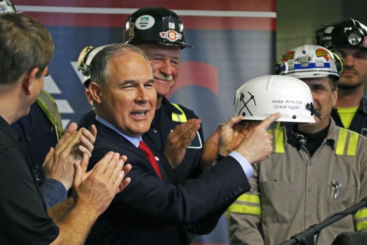 Then-EPA Administrator Scott Pruitt holds up a hardhat he was given during a visit to a coal mine in Sycamore, Pa., in April 2017. A reader warns that his potential successor would continue the culture of cronyism and corruption that Pruitt fostered at the agency.