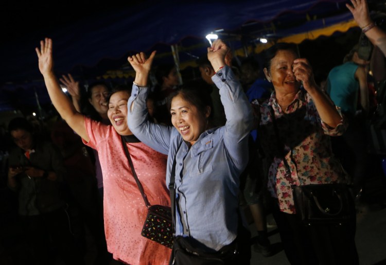 People celebrate Tuesday as divers evacuate the last of 12 boys and their coach trapped in a cave in northern Thailand. A letter writer comments on the world community coming together to help.