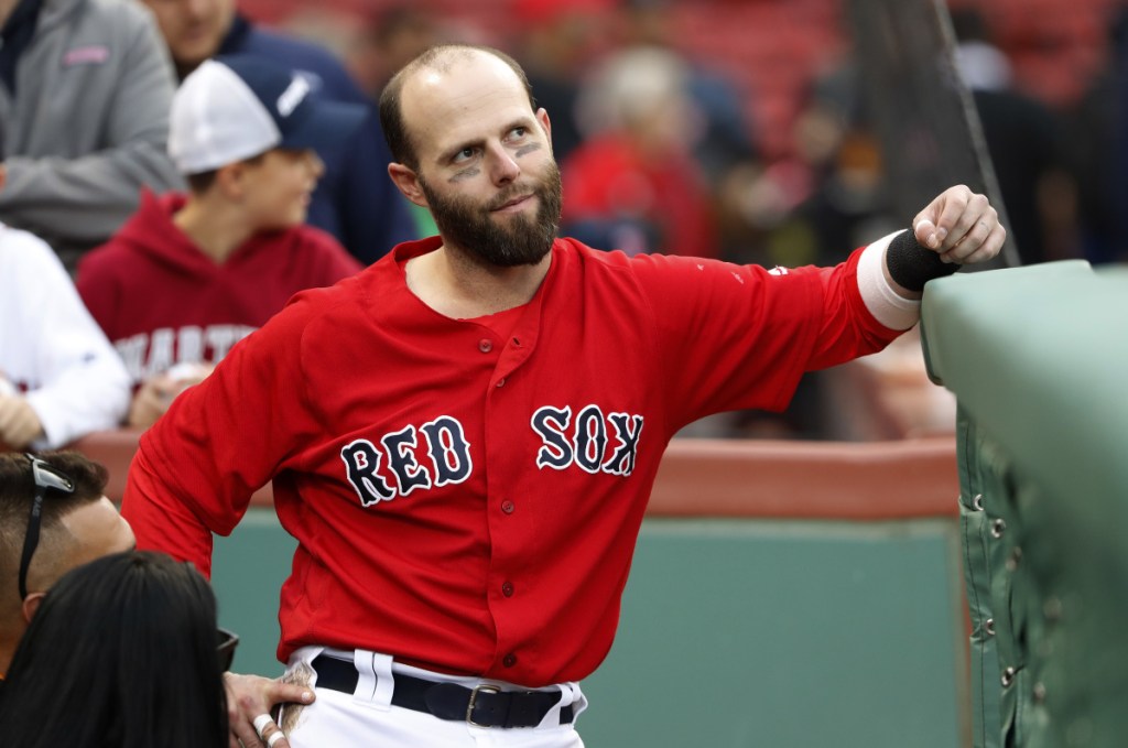 Boston Red Sox second baseman Dustin Pedroia looks on from the dugout before a game last September at Fenway Park in Boston. (AP Photo/Winslow Townson)