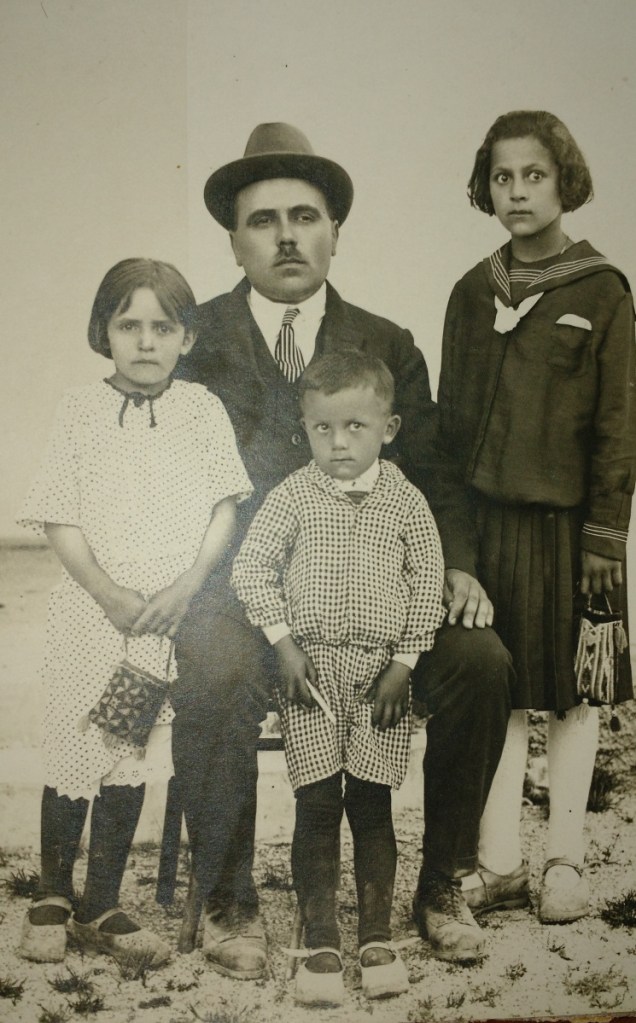 A father and three children pose in the early 1920s. They could not know what history had in store.