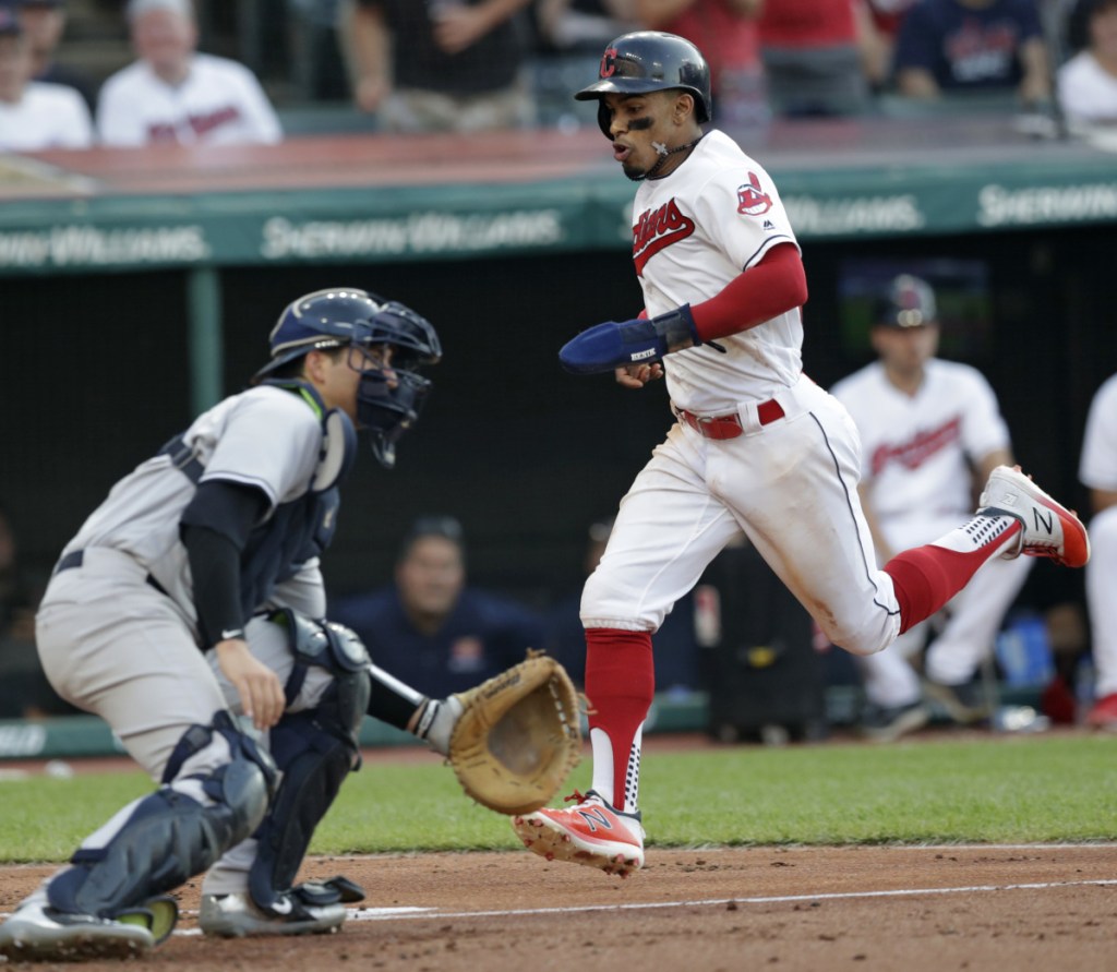 Francisco Lindor scores a run for the Indians as Yankees catcher Kyle Higashioka waits for the late throw Friday night. Cleveland ended a seven-game losing streak against New York dating back to last year's playoffs, holding on for a 6-5 win.