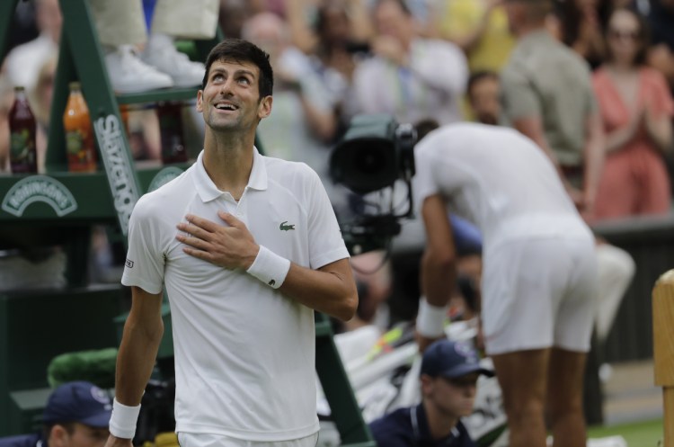 Serbia's Novak Djokovic smiles after defeating Rafael Nadal of Spain during their semifinals match at Wimbledon in London on Saturday.