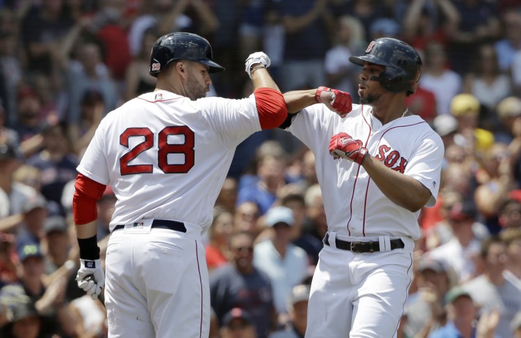 Xander Bogaerts, right, celebrates with J.D. Martinez after hitting a solo home run in the first inning of the Red Sox' 5-2 win over the Blue Jays on Sunday in Boston.