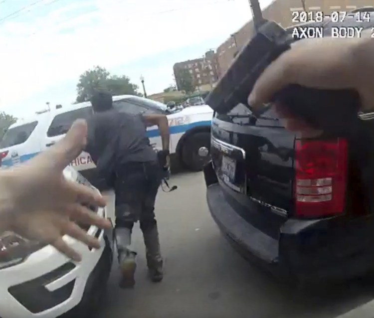 This frame grab from Chicago police body cam video shows authorities trying to apprehend a suspect, center, who appeared to be armed Saturday. The suspect was fatally shot by police during the confrontation.