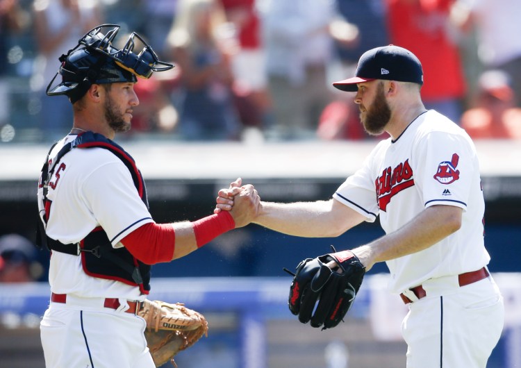 Cleveland catcher Yan Gomes, left, and closer Cody Allen celebrate Sunday after the 5-2 win over the New York Yankees. The teams split a four-game series.