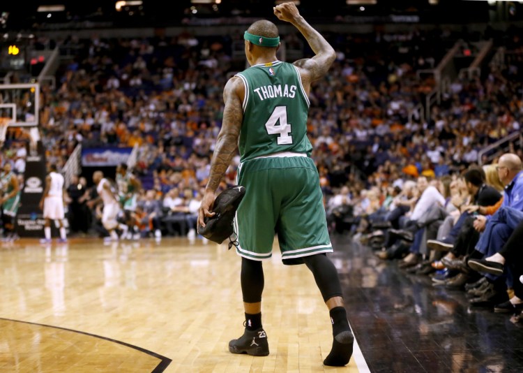 Phoenix Suns Boston Celtics' Isaiah Thomas (4) pumps his fist after losing his shoe during the second half of an NBA basketball game against the Phoenix Suns Monday, Feb. 23, 2015, in Phoenix. The Celtics won 115-110. (AP Photo/Matt York)
