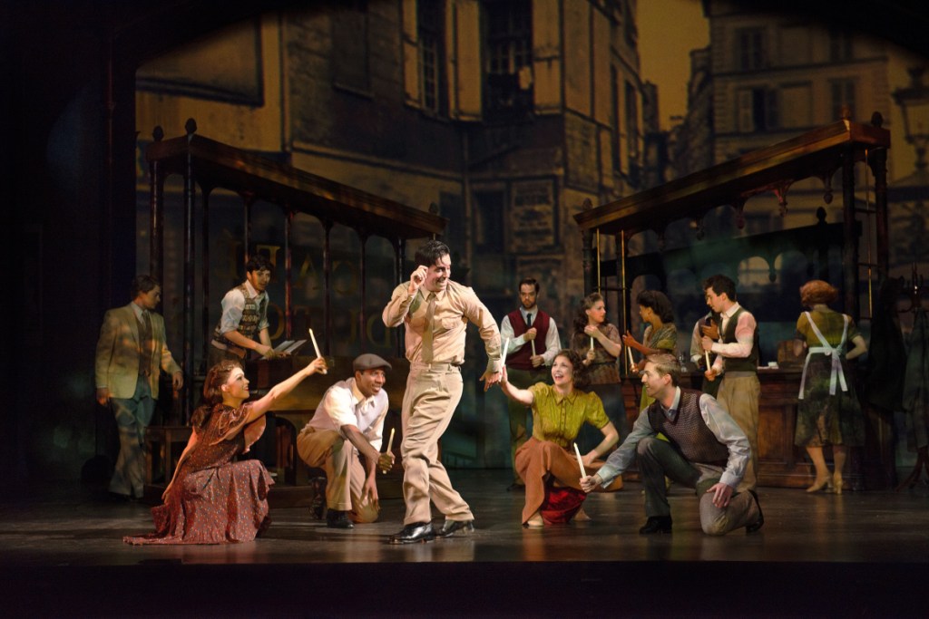 Clyde Alves and the cast in one of the big production numbers of "An American in Paris."